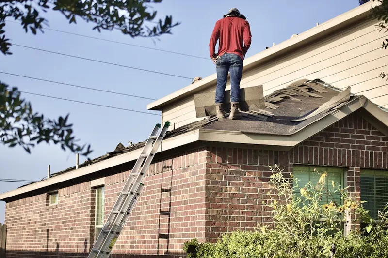 Professional roofer working on a residential roof in Fox Heath